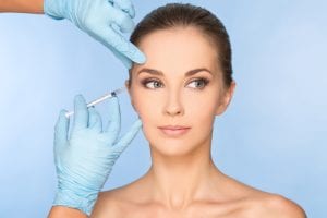 Woman receiving injectable fillers on her crow's feet