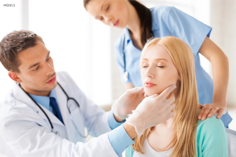 Woman getting her facial structure examined by a doctor.