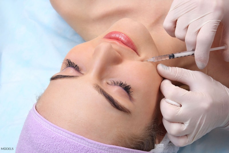 Woman receiving a cosmetic injectable.