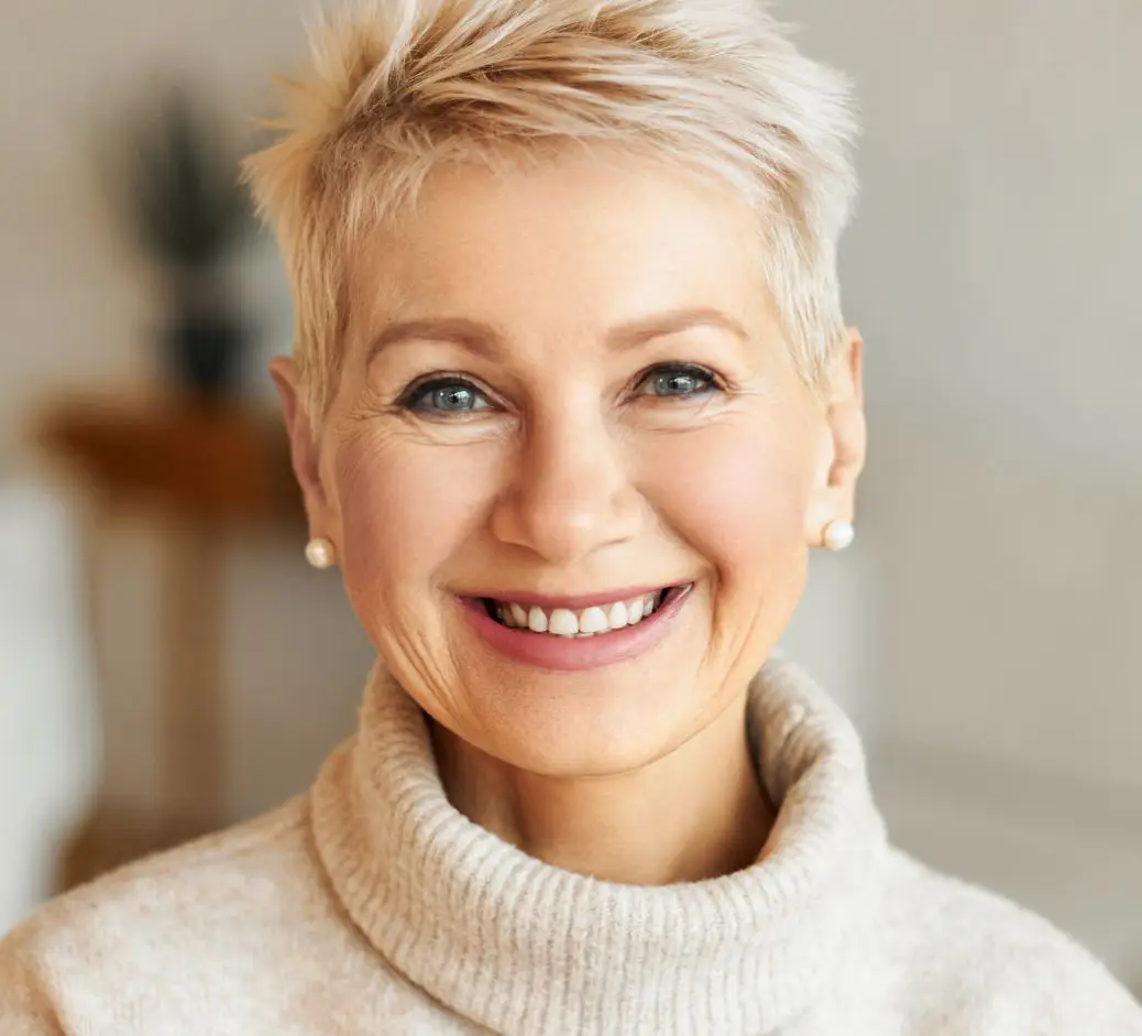 Mature woman with short hair in a cream turtle neck