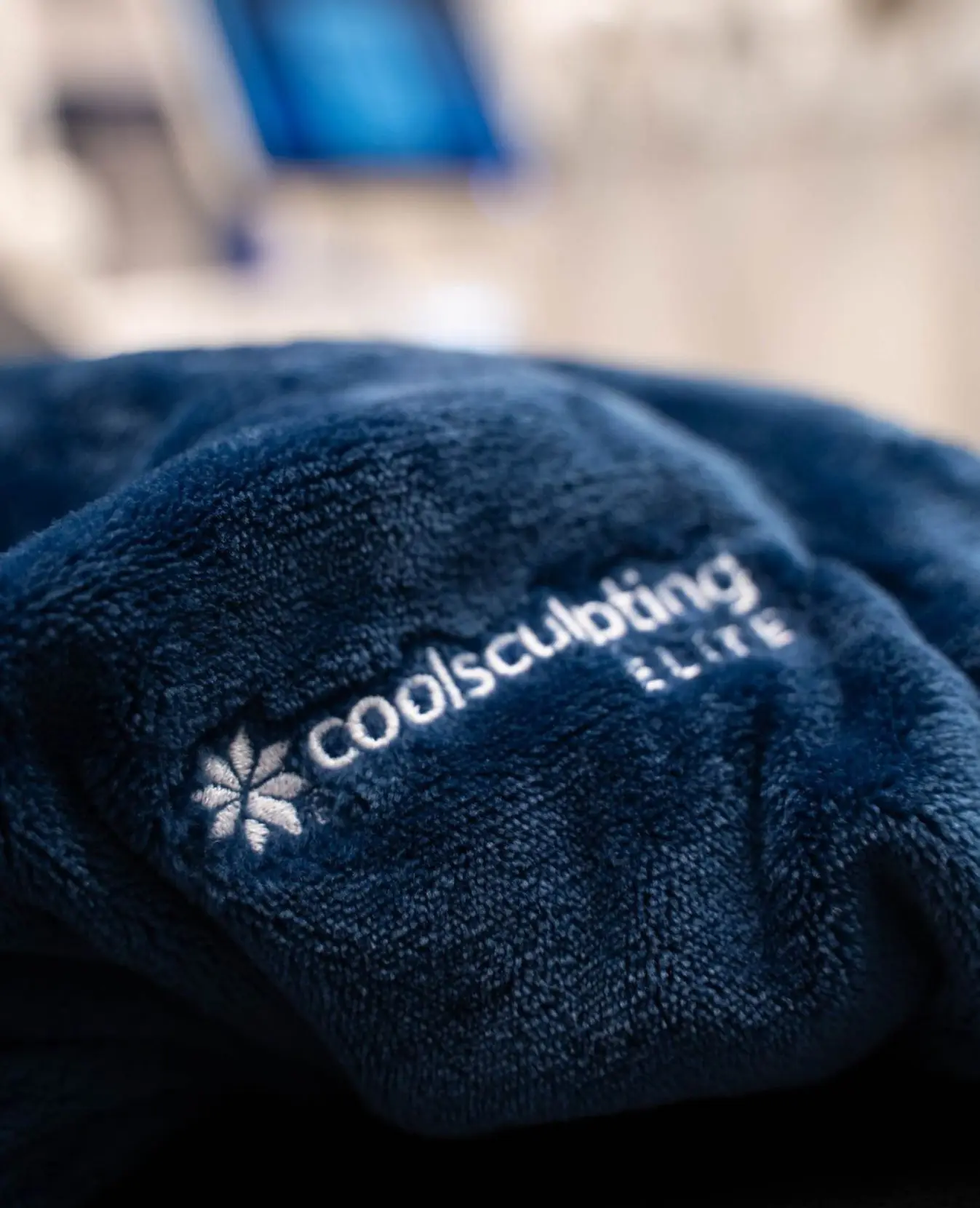 Coolsculpting Elite logo on a blue robe