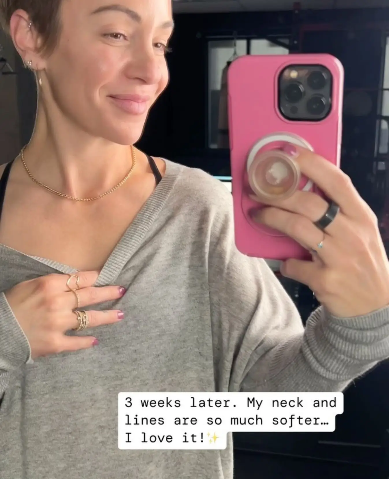 Woman looking at her reflection and taking a selfie of her neck line