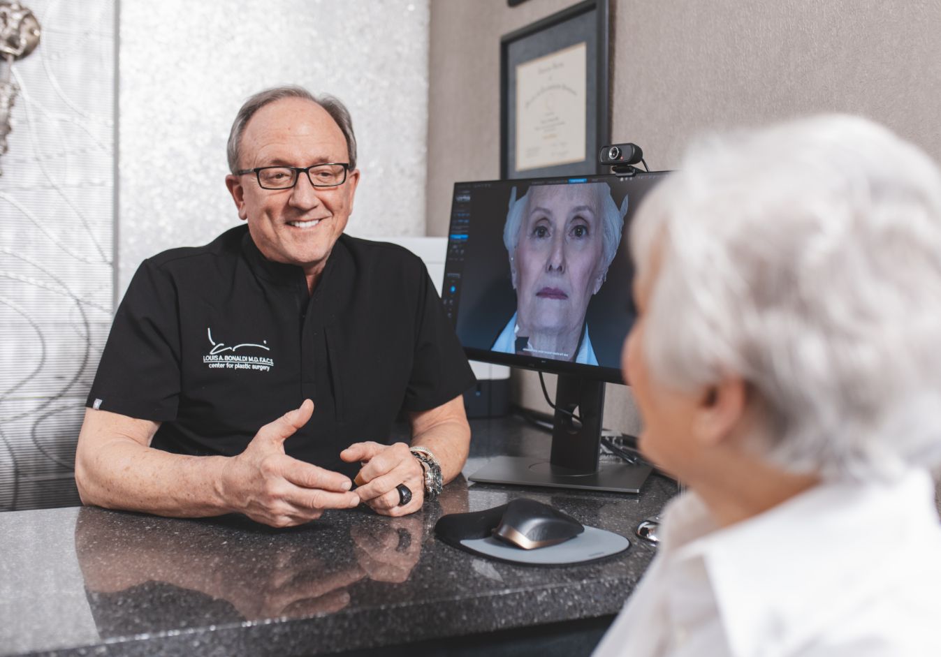 Dr. Bonaldi with a patient having a facial enhancement consultation